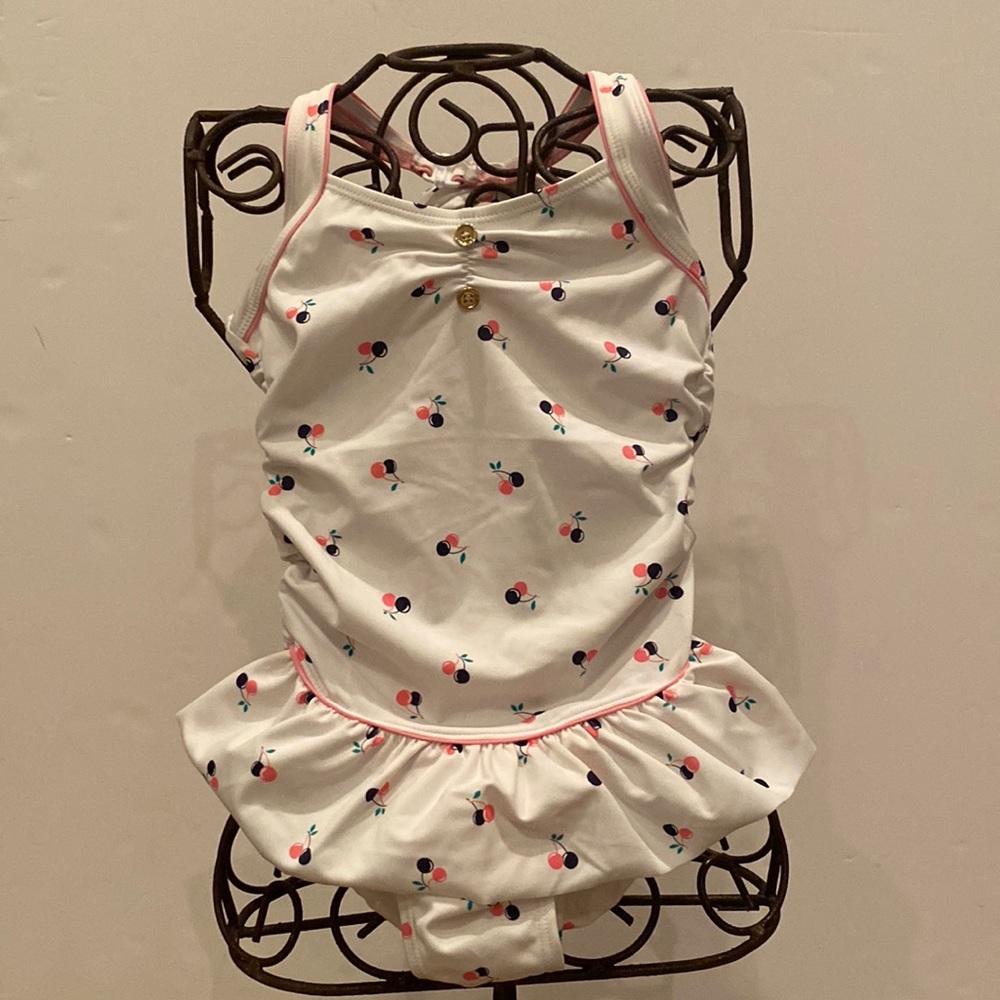 Precious one piece bathing suit. White with pink and navy cherries.